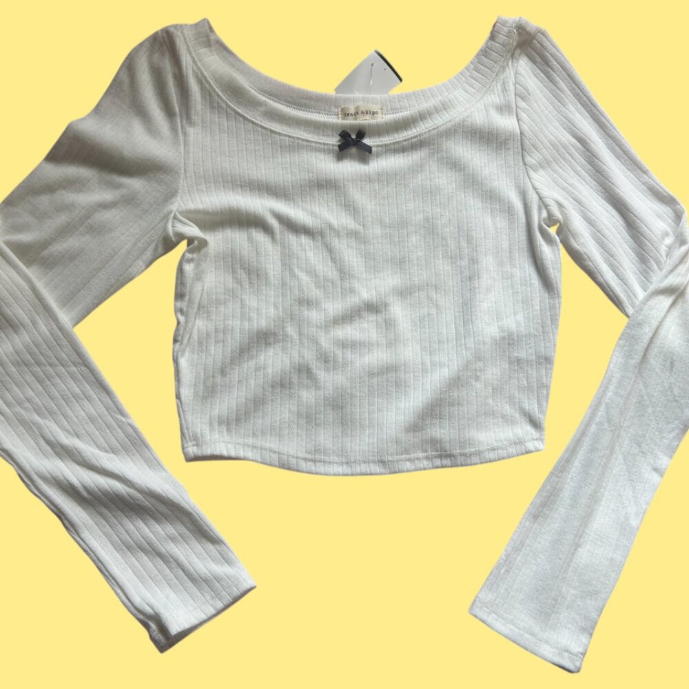White cropped long sleeve top with black bow detail